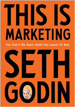 Αυτό είναι ένα στιγμιότυπο οθόνης του εξωφύλλου του This Is Marketing από τον Seth Godin. Το κάλυμμα είναι κάθετο ορθογώνιο με πορτοκαλί φόντο και μαύρο κείμενο. Μια φωτογραφία του κεφαλιού του Seth εμφανίζεται στο O του επωνύμου του.